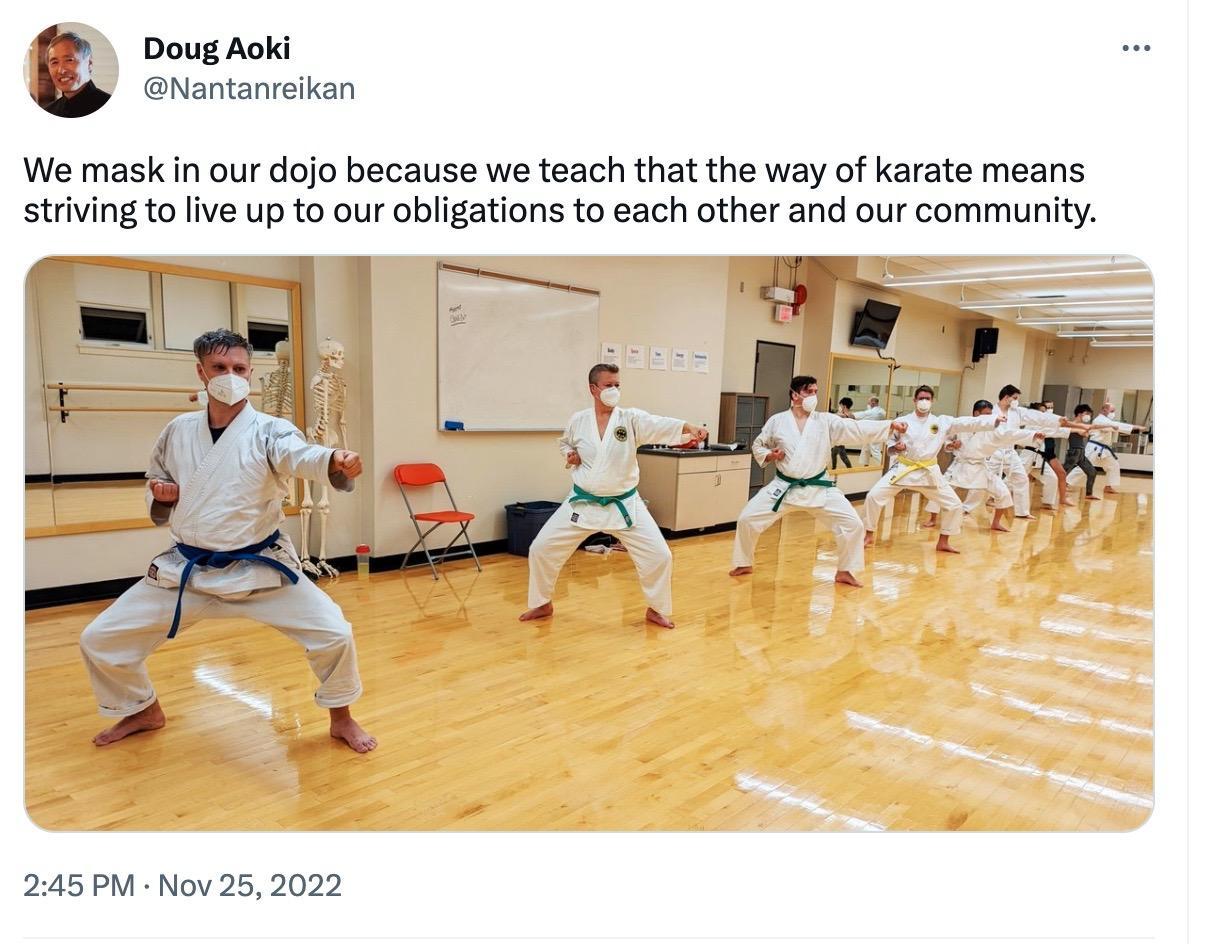 A tweet from Doug Aoki shows a photo of martial artists wearing respirators in their dojo and practicing martial arts. The caption reads "We mask in our dojo because we teach that the way of karate means striving to live up to our obligations to each other and our community."